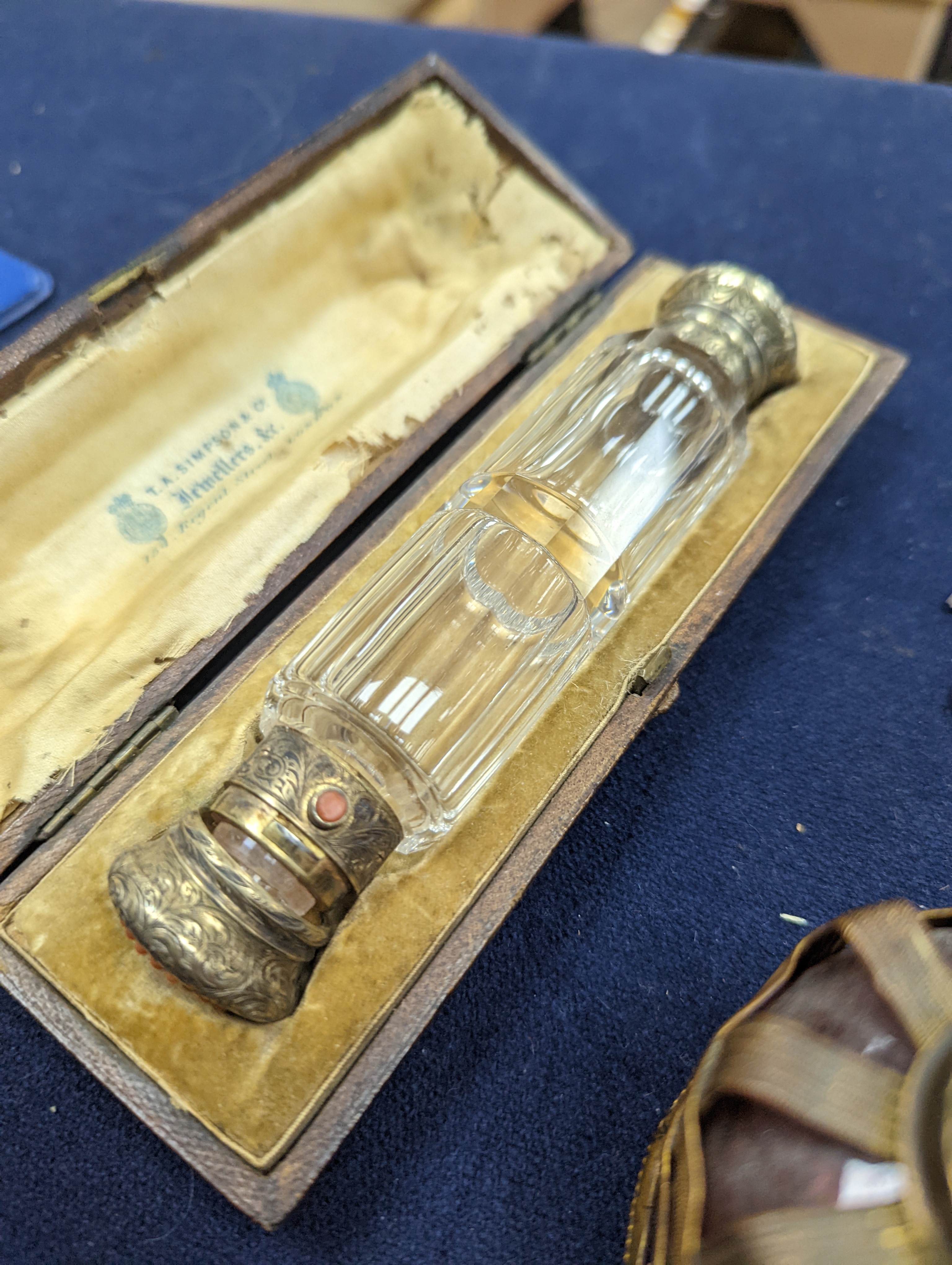 A cased Victorian engraved gilt white metal and coral set double ended scent bottle, 13.4cm, a silver cigar cutter, a belt, a silver buckle, gilt and cranberry perfume bottle, etc.